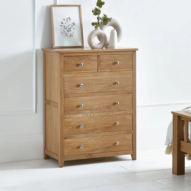 Wooden dresser with multiple drawers on a white background