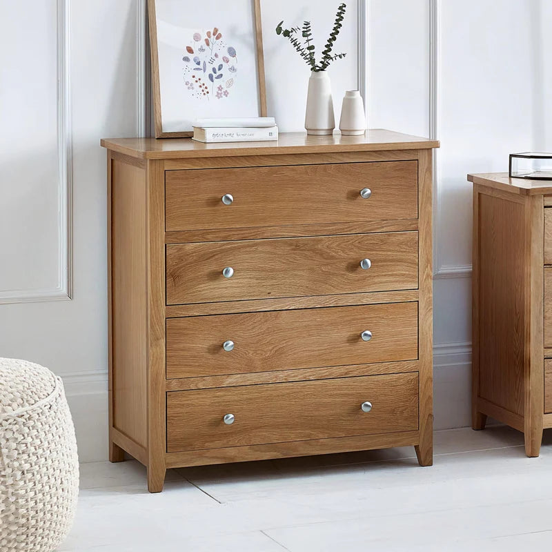 Wooden dresser with four drawers on a white background