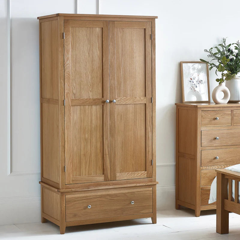 Wooden wardrobe with two doors and a drawer on a white background