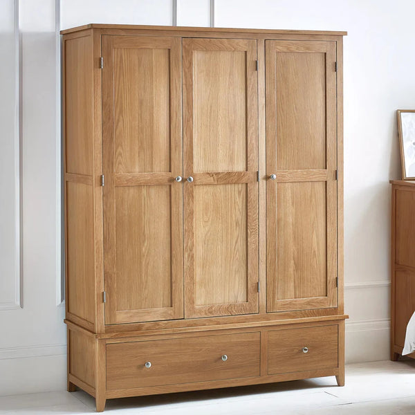 three door two drawer oak wardrobe in a bedroom setting