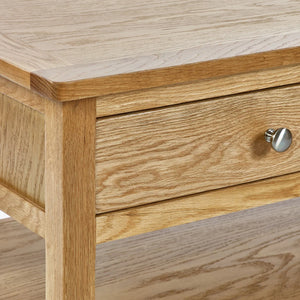 Wooden drawer with a metallic handle on a wooden surface