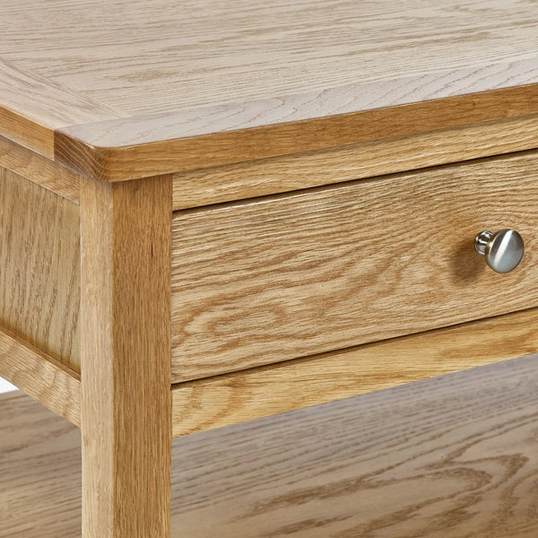 Wooden drawer with a metallic handle on a wooden surface