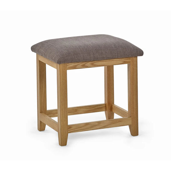 Wooden stool with a gray cushioned top on a white background