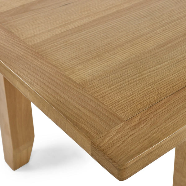 Close-up of a wooden table with a light brown finish on a white background