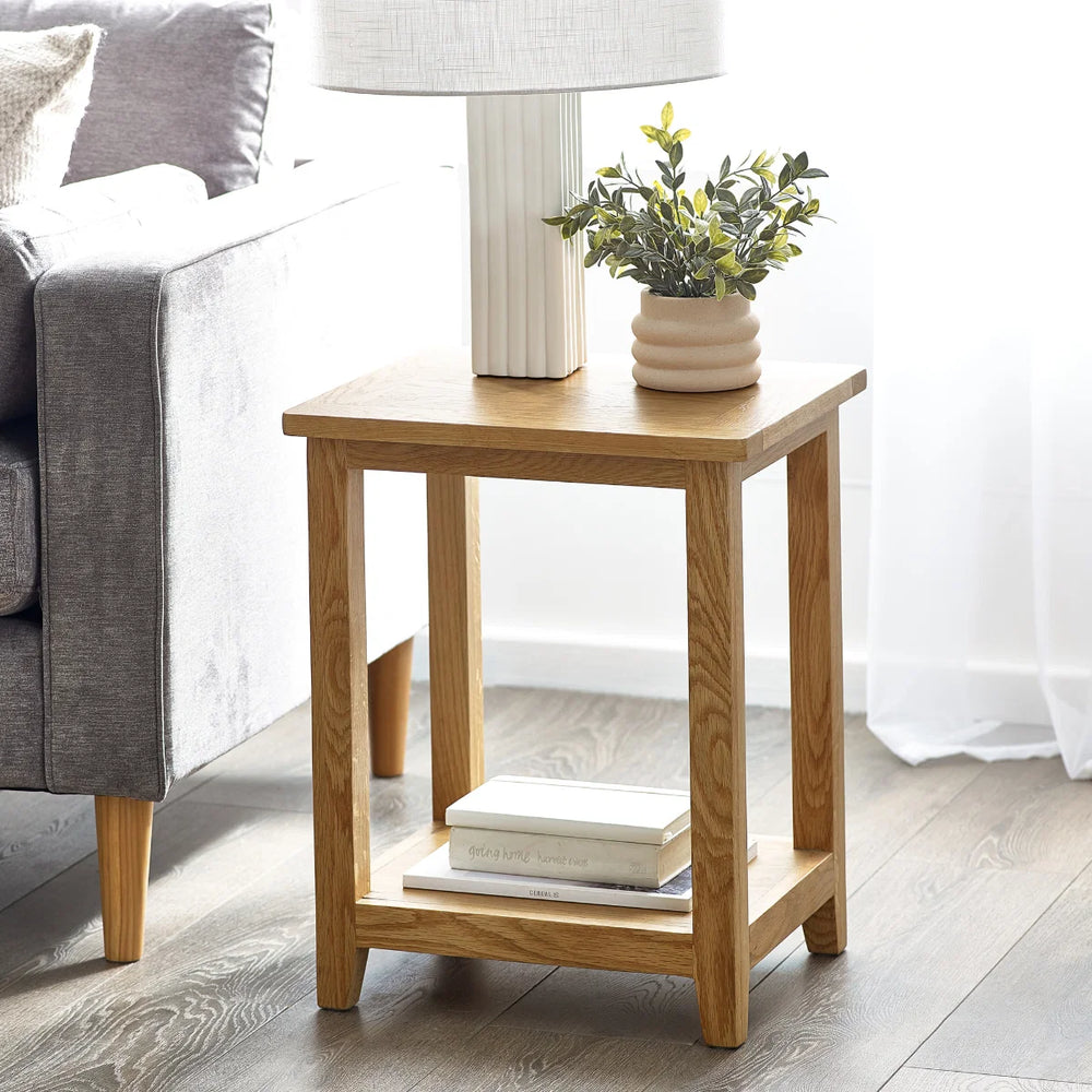 Wooden side table with a shelf on a white background