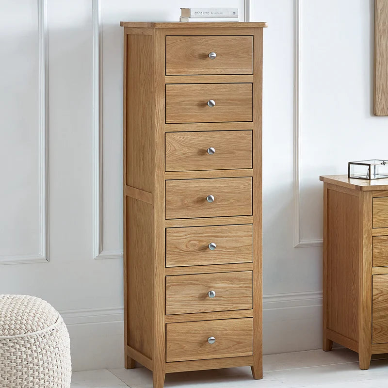Wooden dresser with seven drawers on a white background