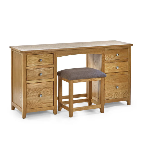 Wooden desk with multiple drawers and a matching stool on a white background
