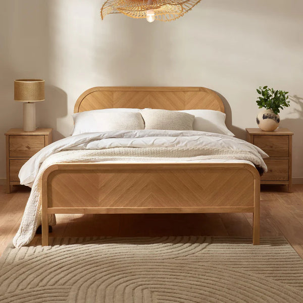 Wooden bed with white bedding in a bedroom setting