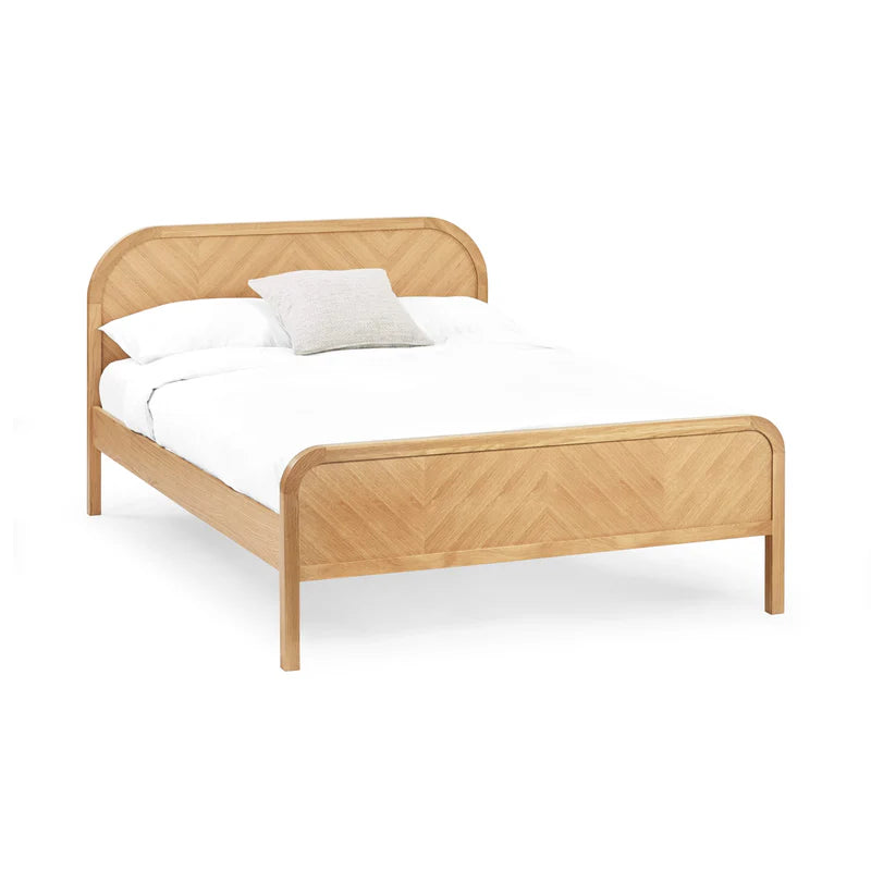 Wooden bed frame with white mattress and pillow on a white background