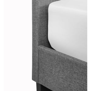 Grey upholstered bed frame with white cushion on a white background