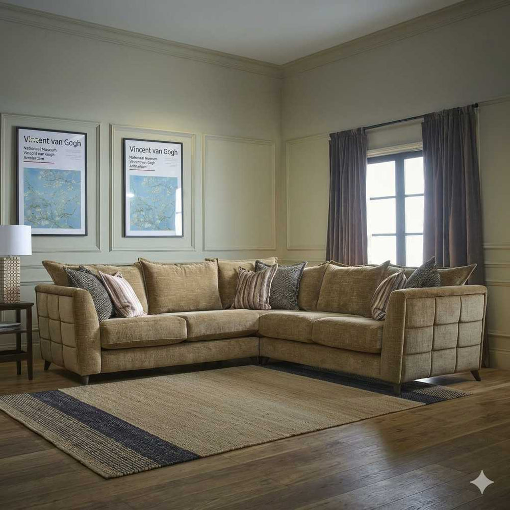 Living room with a beige sectional sofa, framed artwork, and a lamp.