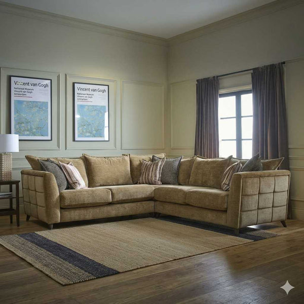 Living room with a beige sectional sofa, framed artwork, and a lamp.