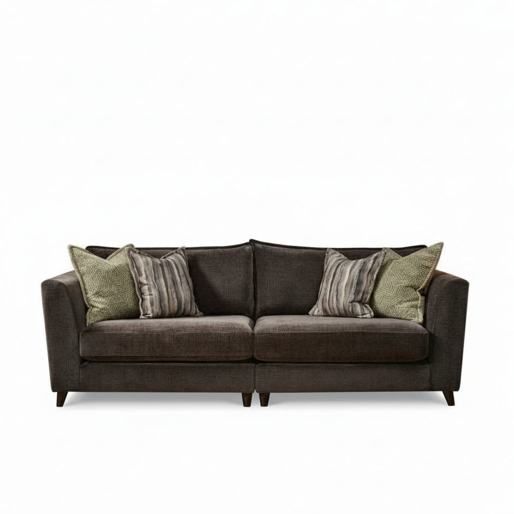 Brown sofa with patterned cushions on a white background