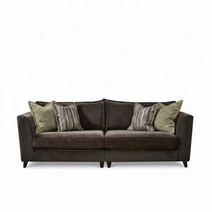 Brown sofa with patterned cushions on a white background