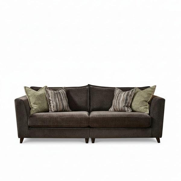 Brown sofa with patterned cushions on a white background