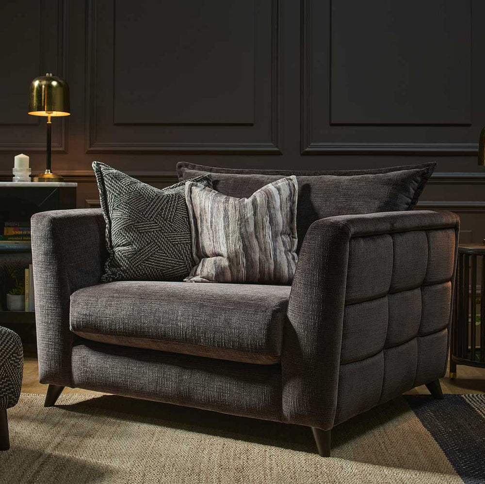 Brown sofa with patterned cushions on a white background