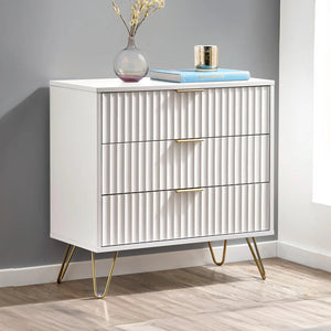 White dresser with gold legs in a room setting