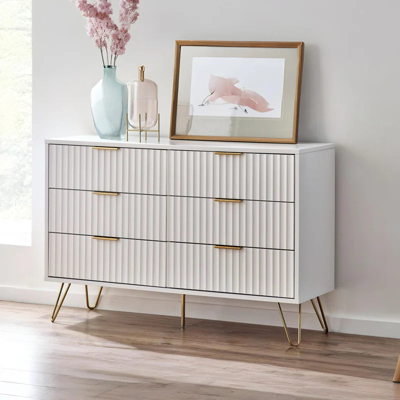 White dresser with gold accents on a white background