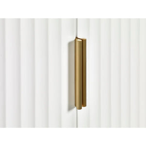 Gold cabinet handle on a white cabinet door