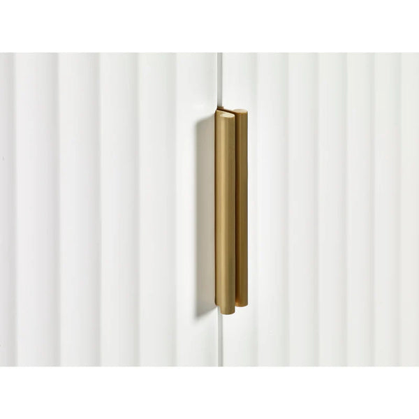 Gold cabinet handle on a white cabinet door