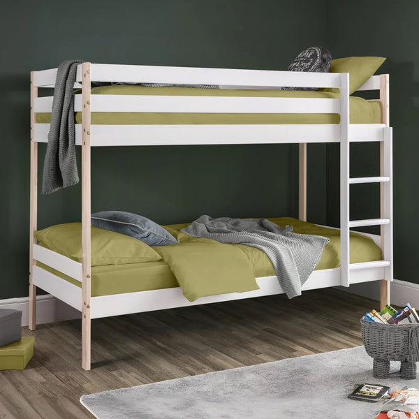 Bunk bed with green mattresses and white frame against a dark wall.