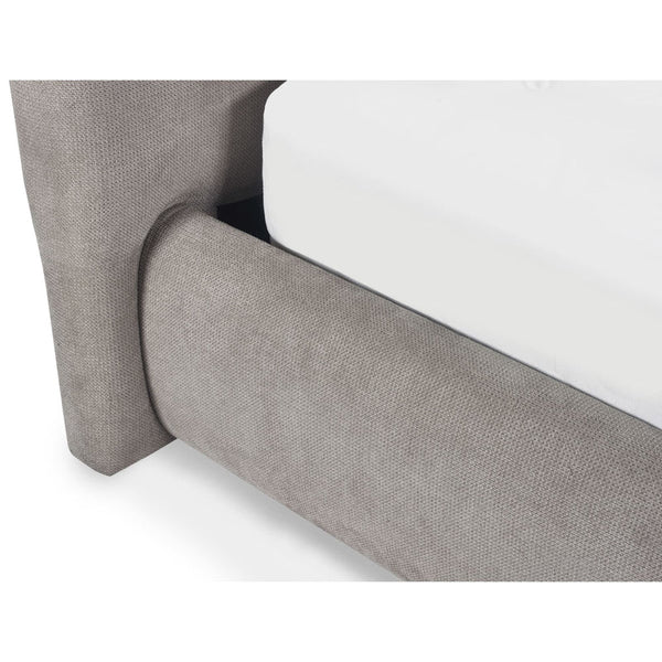 Gray upholstered bed frame corner on a white background