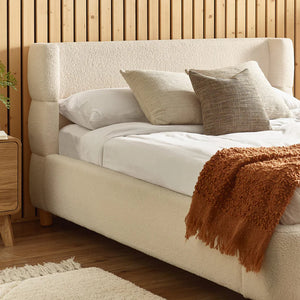 cream boucle bed in modern bedroom