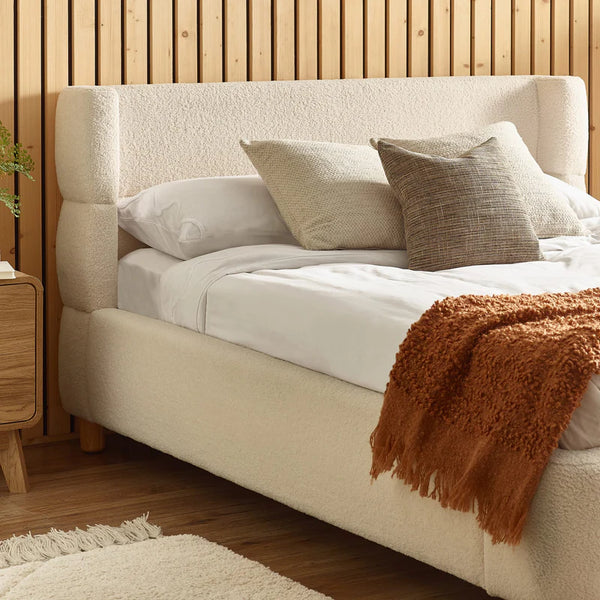 cream boucle bed in modern bedroom