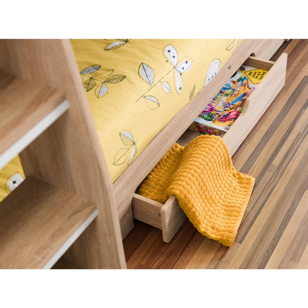 Wooden bed with yellow bedding and a yellow blanket on a wooden floor.