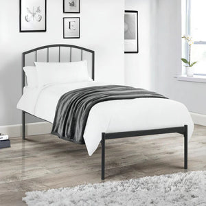 Bedroom with a black metal bed frame, white bedding, and decorative elements.