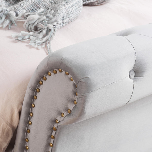 Close-up of a gray bed buttoned footend with studded detail
