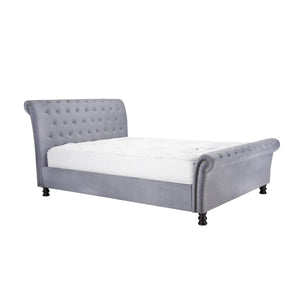 Gray upholstered bed with white mattress on a white background