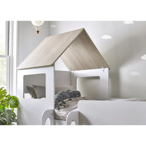Children's bed with a wooden roof in a bright room