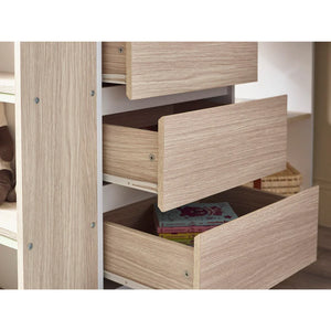 Wooden dresser with open drawers revealing books inside.