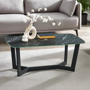 Coffee table with black marble top and black metal legs in a living room setting.