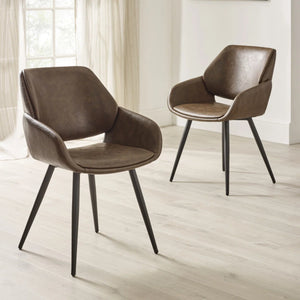 Two brown chairs with black legs on a light wooden floor.