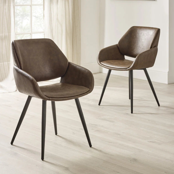 Two brown chairs with black legs on a light wooden floor.