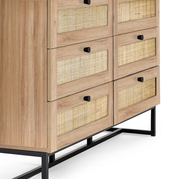 Wooden dresser with woven drawers on a white background