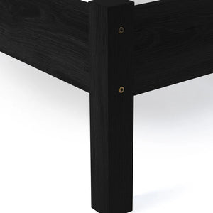 Close-up of a black wooden bed frame corner on a white background