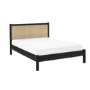 Bed with black frame and woven backrest on a white background