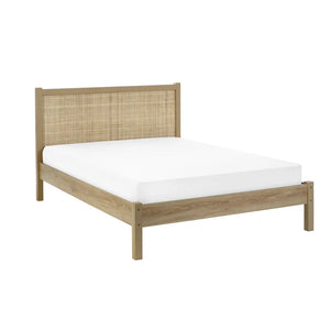 Wooden bed frame with woven headboard and white mattress on a white background