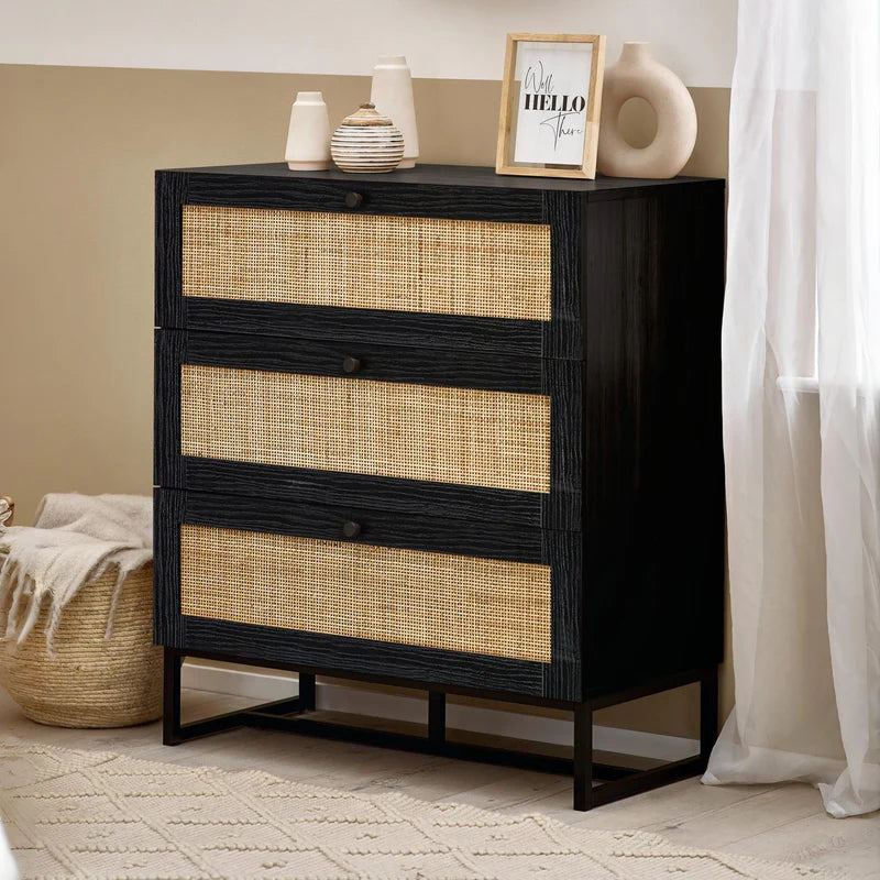 Black dresser with rattan drawers on a white background