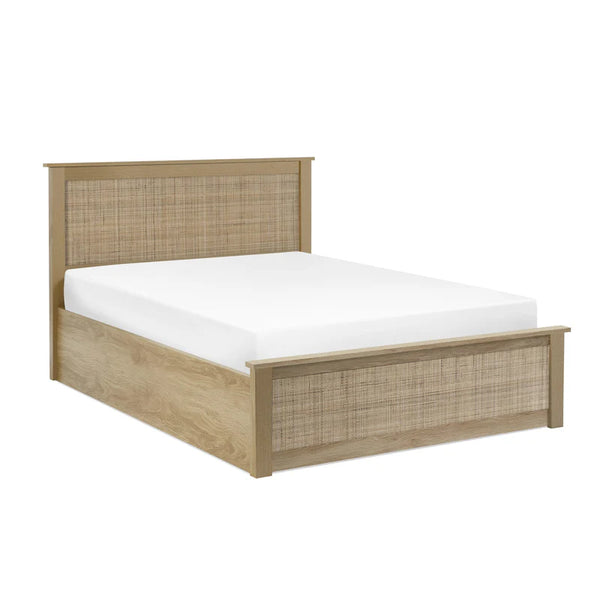 Wooden bed frame with wicker headboard and footboard on a white background