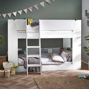 White bunk bed in a room with decorative elements and furniture.
