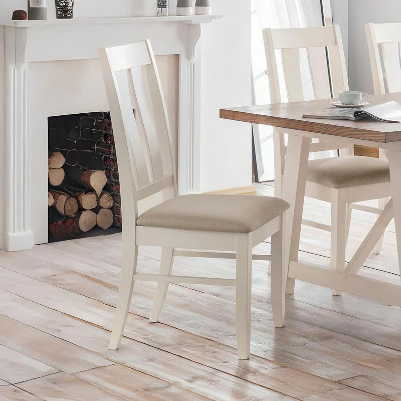 Two white chairs with beige seats on a white background