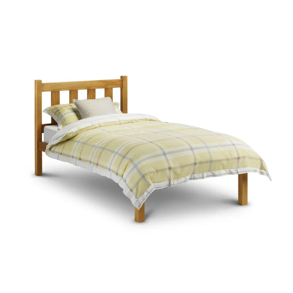 Bed with wooden frame and yellow checkered duvet on a white background