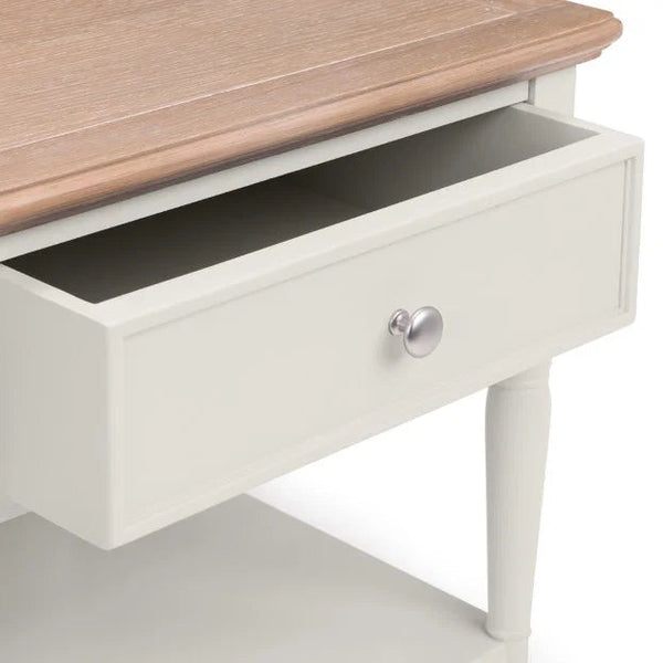 White desk with a wooden top and open drawer on a white background