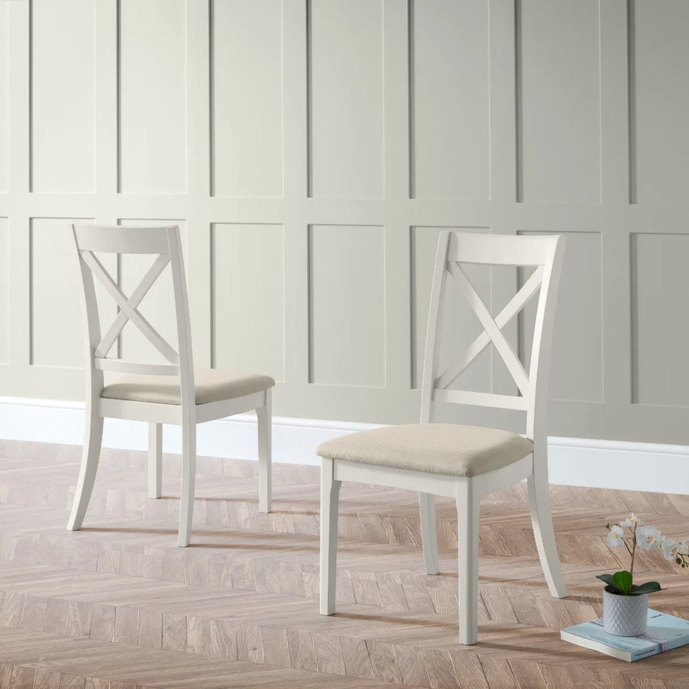 Two white chairs with beige seats on a white background