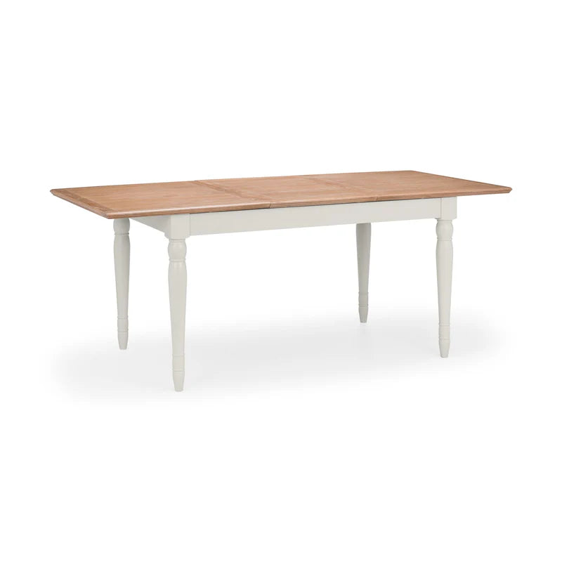 Dining table with wooden top and white base on a white background