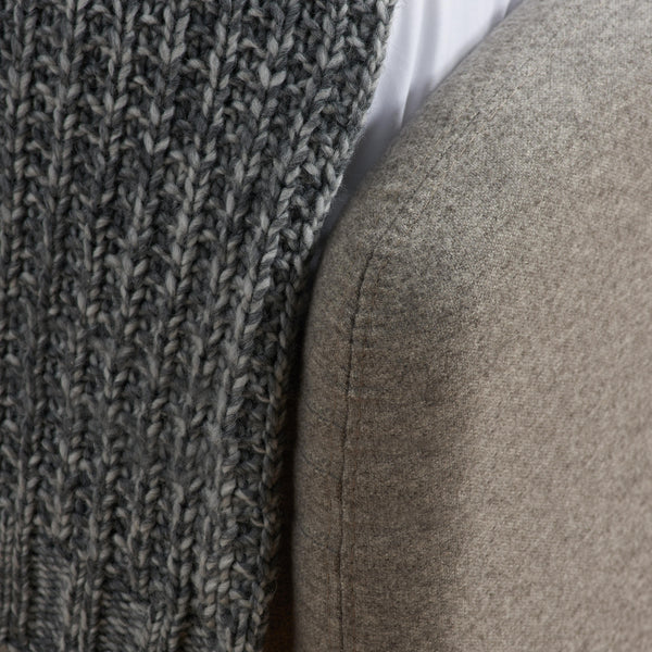 Close-up of a textured gray footend and grey blanket